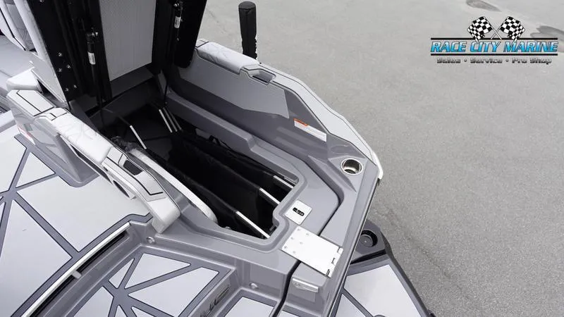 Slide: The Image of 2025 Nautique Super Air Nautique G25 Paragon boat storage compartment, Race City Marine logo visible. - 43