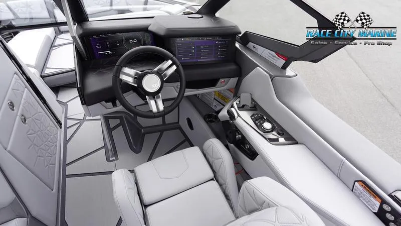 Slide: The Image of 2025 Nautique Super Air Nautique G25 Paragon interior with modern dashboard and steering wheel. - 44