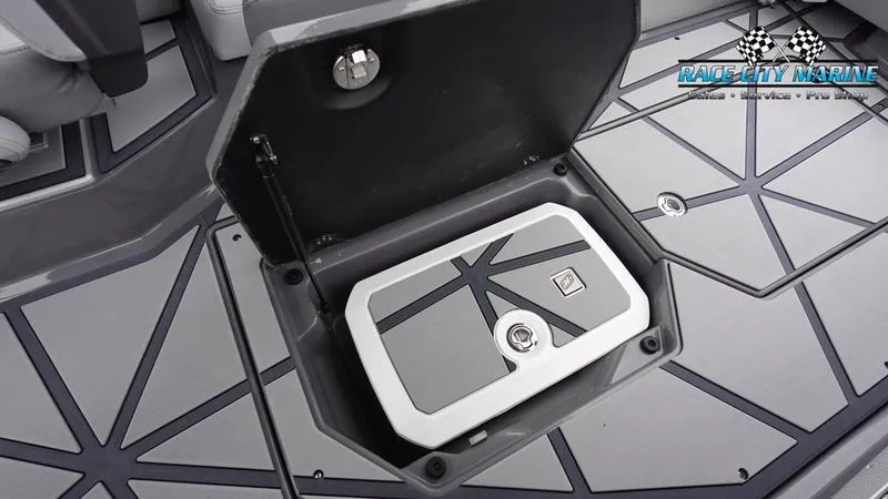 Slide: The Image of 2025 Nautique Super Air G25 Paragon storage compartment with geometric flooring design. - 46