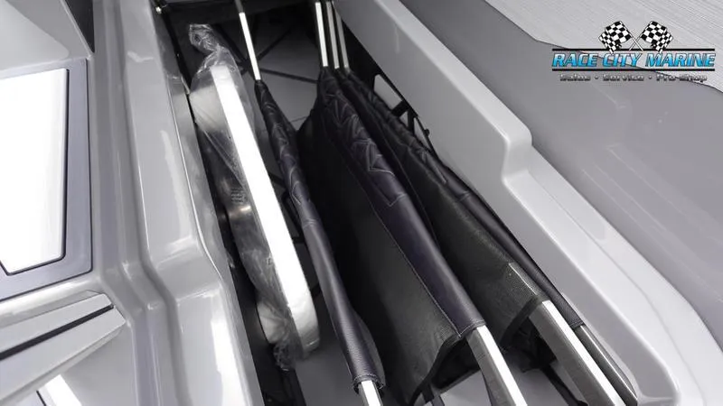 Slide: The Image of 2025 Nautique Super Air Nautique G25 Paragon storage compartment with neatly organized equipment. - 49