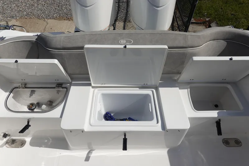 Slide: The Image of 2025 Sea Hunt Ultra 265 SE boat interior with open storage compartments. - 10
