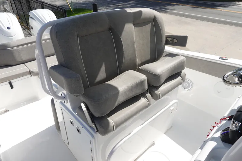 Slide: The Image of 2025 Sea Hunt Ultra 265 SE boat seating, featuring dual cushioned seats and armrests. - 21