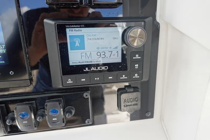 Slide: The Image of JL Audio MediaMaster 105 radio on 2025 Sea Hunt Ultra 265 SE boat dashboard. - 26