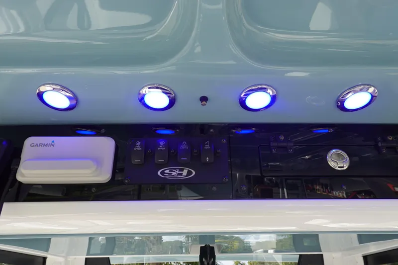 Slide: The Image of Control panel of 2025 Sea Hunt Ultra 265 SE with blue LED lights and Garmin device. - 28