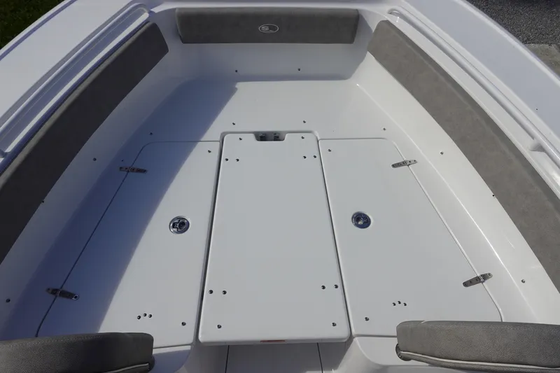 Slide: The Image of 2025 Sea Hunt Ultra 265 SE boat deck with storage compartments and cushioned seating. - 32