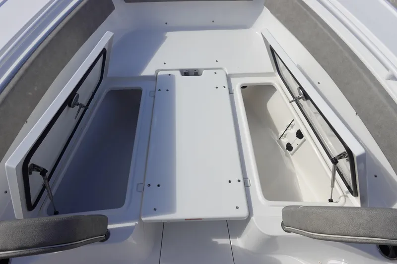 Slide: The Image of 2025 Sea Hunt Ultra 265 SE boat storage compartments with open hatches. - 33