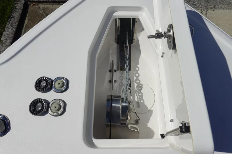 Slide: The Image of 2025 Sea Hunt Ultra 265 SE anchor compartment with chain and winch system. - 39