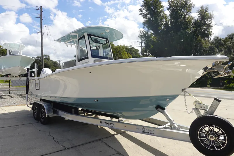 Slide: The Image of 2025 Sea Hunt Ultra 265 SE boat on trailer, parked outdoors. - 4