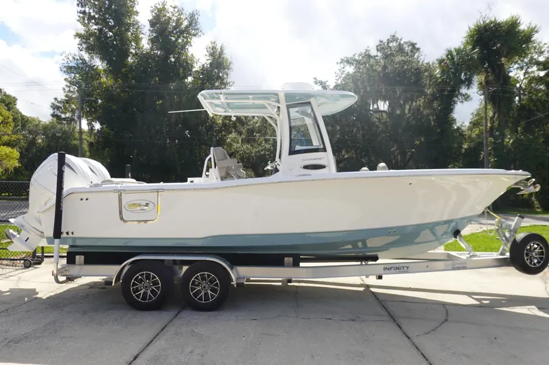Slide: The Image of 2025 Sea Hunt Ultra 265 SE boat on trailer, parked outdoors. - 5