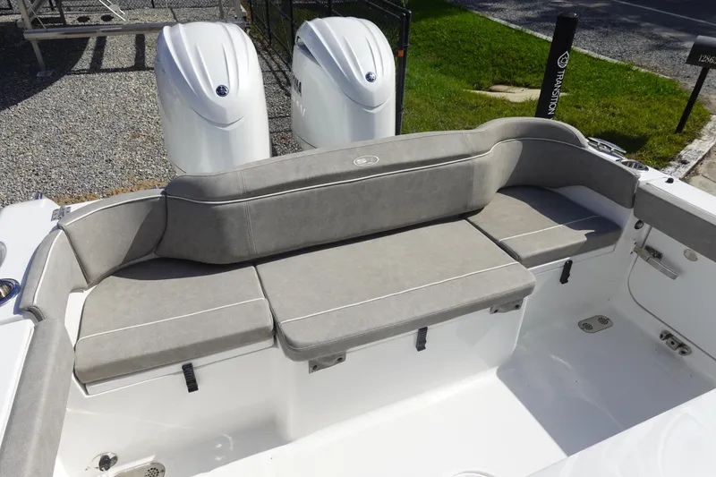 Slide: The Image of 2025 Sea Hunt Ultra 265 SE boat with cushioned seating and dual engines. - 8