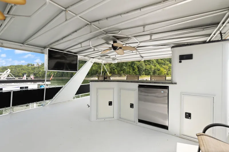Slide: The Image of Outdoor kitchen on 2001 Stardust Cruisers houseboat with TV and ceiling fan. - 11