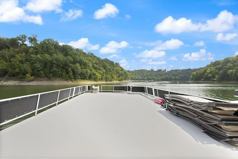 Slide: The Image of 2001 Stardust Cruisers houseboat deck with scenic lake and forest view. - 12