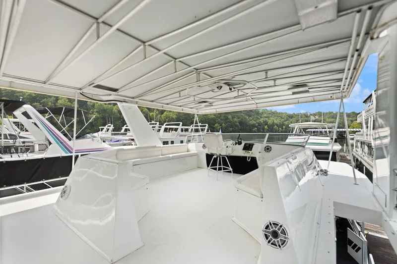 Slide: The Image of Spacious deck of 2001 Stardust Cruisers 18 x 100 houseboat, featuring sleek white design. - 14