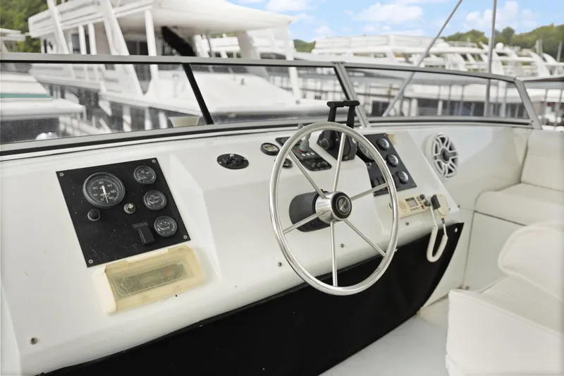 Slide: The Image of 2001 Stardust Cruisers houseboat helm with steering wheel and control panel. - 17