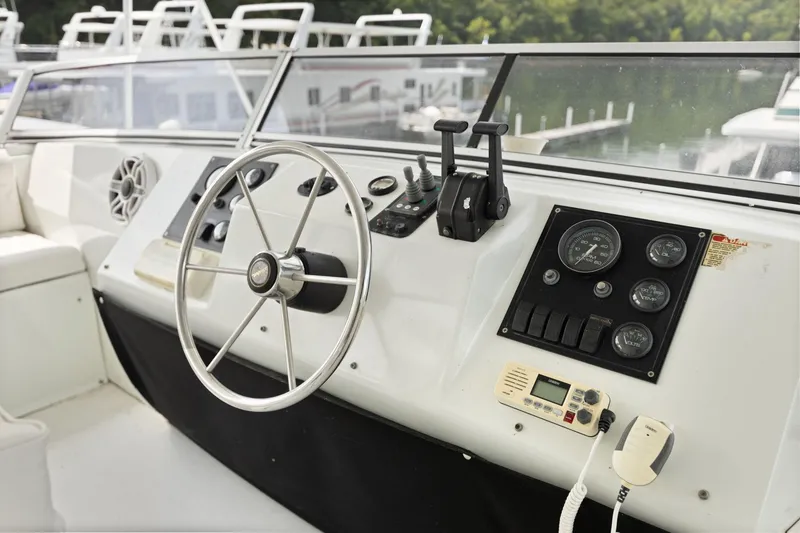 Slide: The Image of 2001 Stardust Cruisers houseboat helm with steering wheel, controls, and gauges. - 18