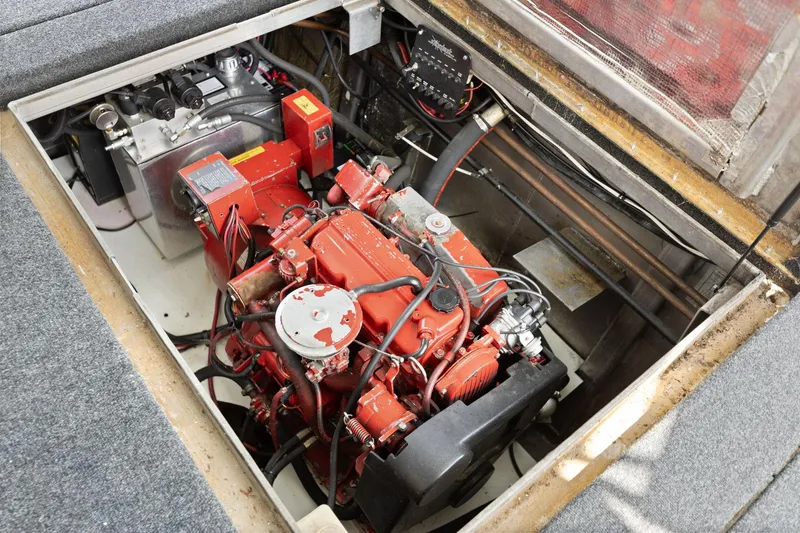 Slide: The Image of Engine compartment of a 2001 Stardust Cruisers 18 x 100 houseboat, featuring a red engine. - 22