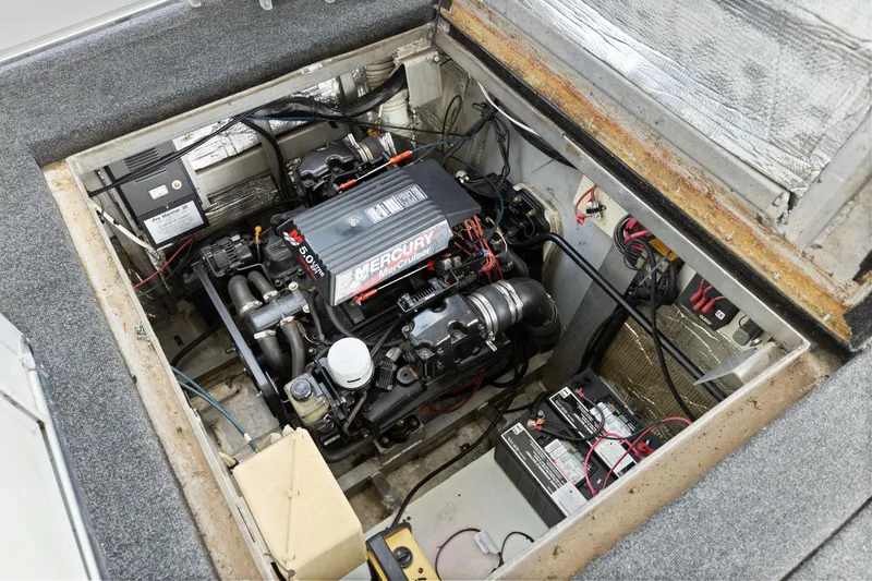 Slide: The Image of Engine compartment of a 2001 Stardust Cruisers 18 x 100 houseboat, featuring a Mercury engine. - 23