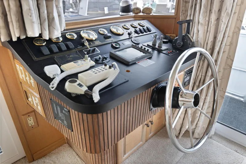 Slide: The Image of Control panel of a 2001 Stardust Cruisers 18 x 100 houseboat with steering wheel and instruments. - 30