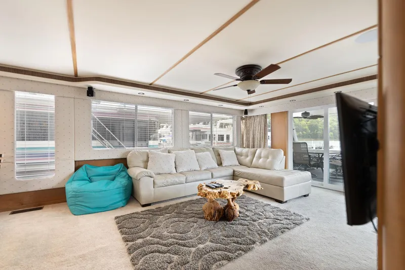 Slide: The Image of Luxurious 2001 Stardust Cruisers houseboat interior with plush seating and modern decor. - 31