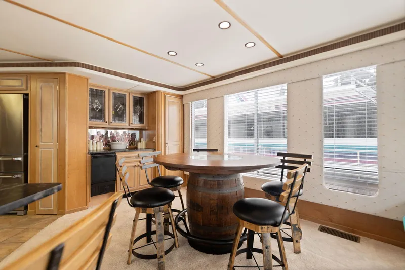 Slide: The Image of Luxurious 2001 Stardust Cruisers houseboat interior with round table and bar stools. - 33