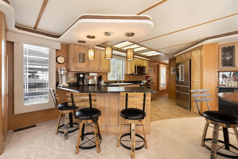 Slide: The Image of Luxurious 2001 Stardust Cruisers houseboat kitchen with modern amenities and stylish bar seating. - 34