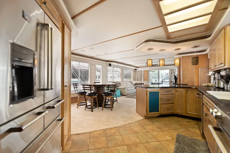 Slide: The Image of Luxurious 2001 Stardust Cruisers houseboat interior with modern kitchen and dining area. - 35