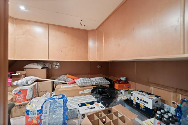 Slide: The Image of Storage room in a 2001 Stardust Cruisers houseboat, filled with boxes and supplies. - 38