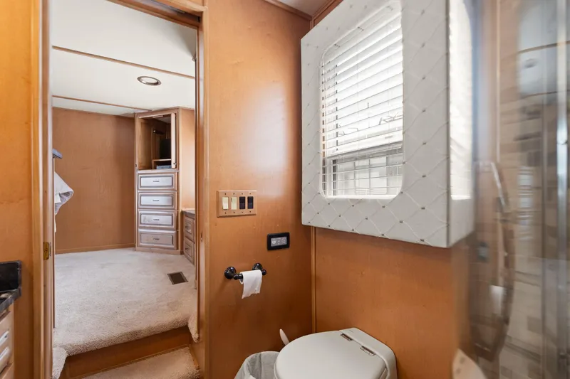 Slide: The Image of Interior of 2001 Stardust Cruisers houseboat bathroom with window and adjacent bedroom. - 44