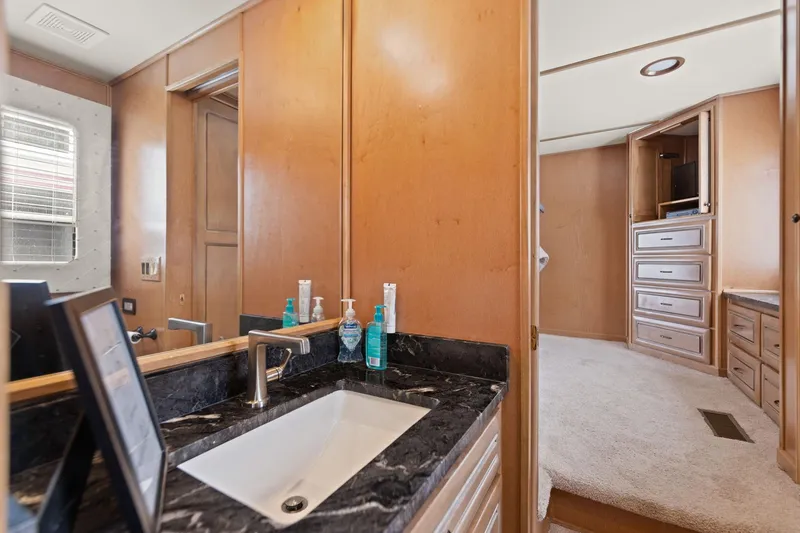 Slide: The Image of Luxurious bathroom interior of 2001 Stardust Cruisers houseboat with modern sink and wooden cabinetry. - 45
