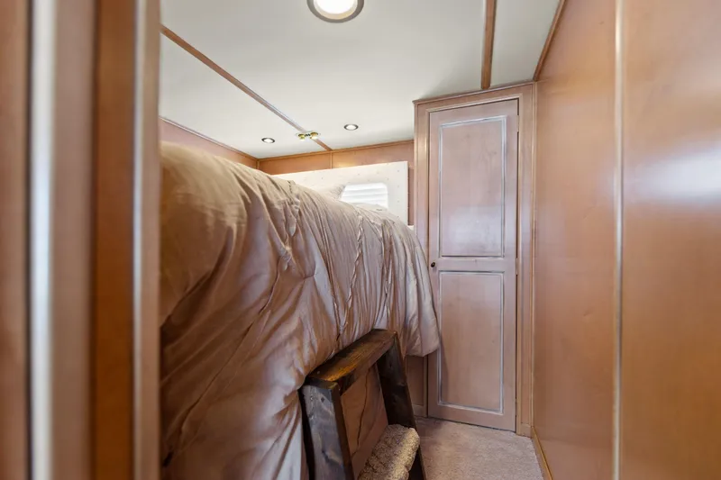 Slide: The Image of Cozy bedroom interior on 2001 Stardust Cruisers houseboat with wooden cabinetry and soft lighting. - 48