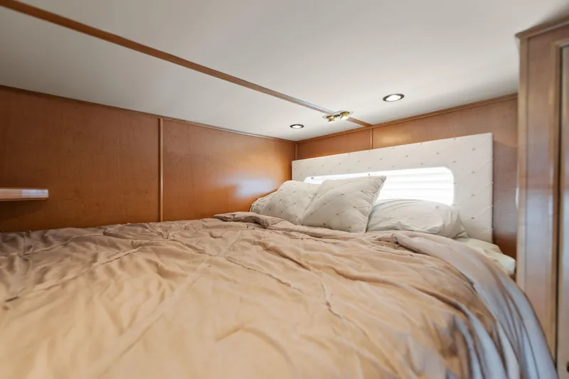 Slide: The Image of Cozy bedroom in 2001 Stardust Cruisers 18 x 100 houseboat with wood paneling and soft bedding. - 49