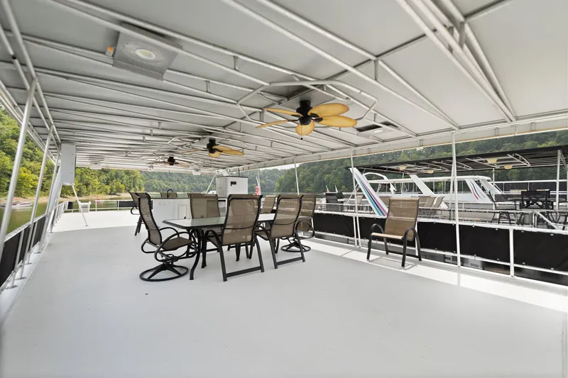Slide: The Image of Spacious deck of 2001 Stardust Cruisers houseboat with seating and ceiling fans. - 7