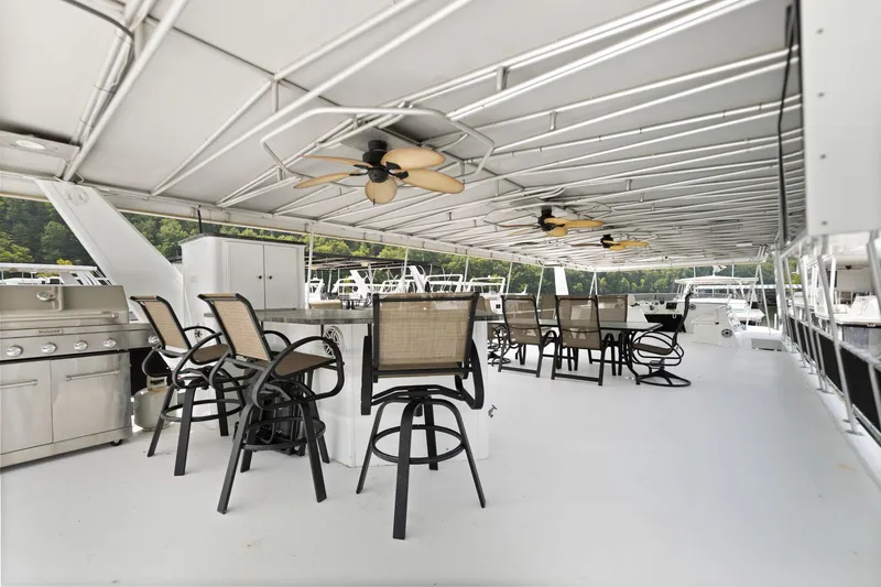 Slide: The Image of Spacious deck of 2001 Stardust Cruisers houseboat with seating and ceiling fans. - 9