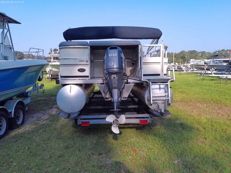 Slide: The Image of 2006 Odyssey Pontoons 218 DLX on trailer, rear view with outboard motor. - 2