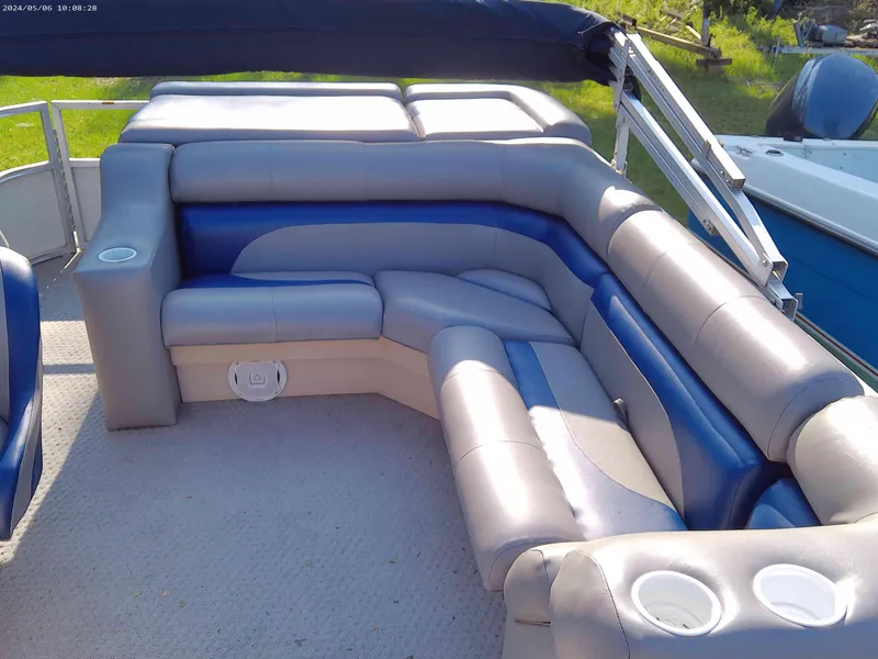 Slide: The Image of 2006 Odyssey Pontoons 218 DLX interior with plush seating and cup holders. - 3