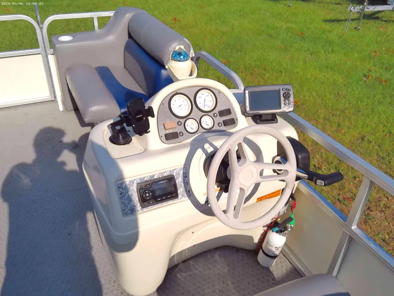 Slide: The Image of 2006 Odyssey Pontoons 218 DLX boat helm with steering wheel and gauges. - 5