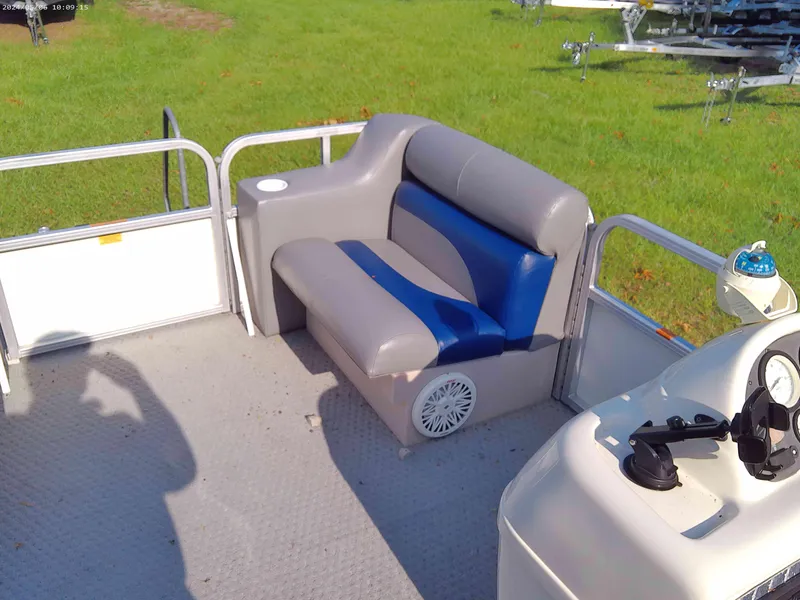 Slide: The Image of 2006 Odyssey Pontoons 218 DLX interior with gray and blue seating on a sunny day. - 8