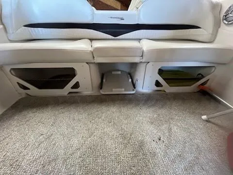 Slide: The Image of 2009 Glastron GT205 boat interior with white seating and storage compartments. - 10