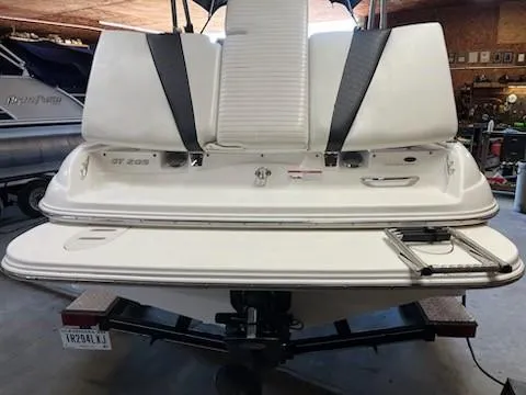 Slide: The Image of 2009 Glastron GT205 boat rear view with swim platform and ladder in a garage. - 3