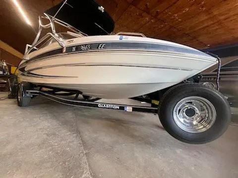 Slide: The Image of 2009 Glastron GT205 boat on trailer in garage setting. - 9