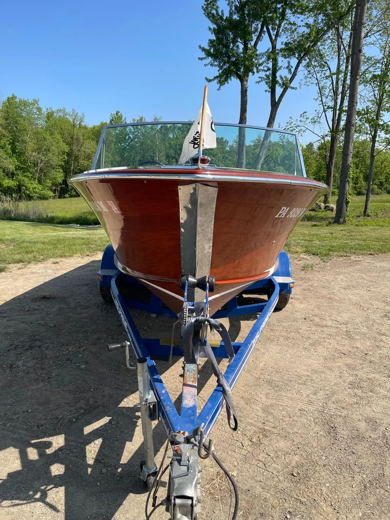 Slide: The Image of 1966 Century Resorter boat on trailer, parked outdoors with trees in the background. - 11
