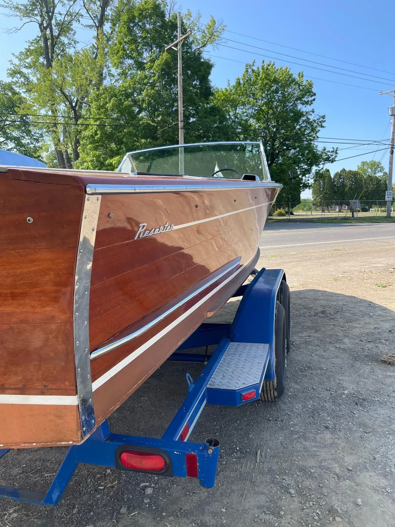 Slide: The Image of 1966 Century Resorter boat on trailer, showcasing polished wood finish and classic design. - 14