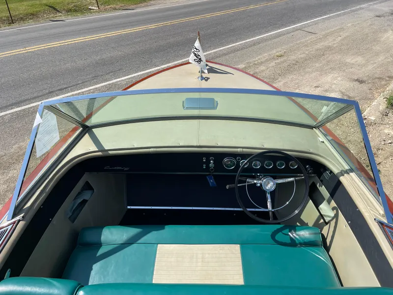 Slide: The Image of 1966 Century Resorter boat interior with teal seats and classic steering wheel. - 15