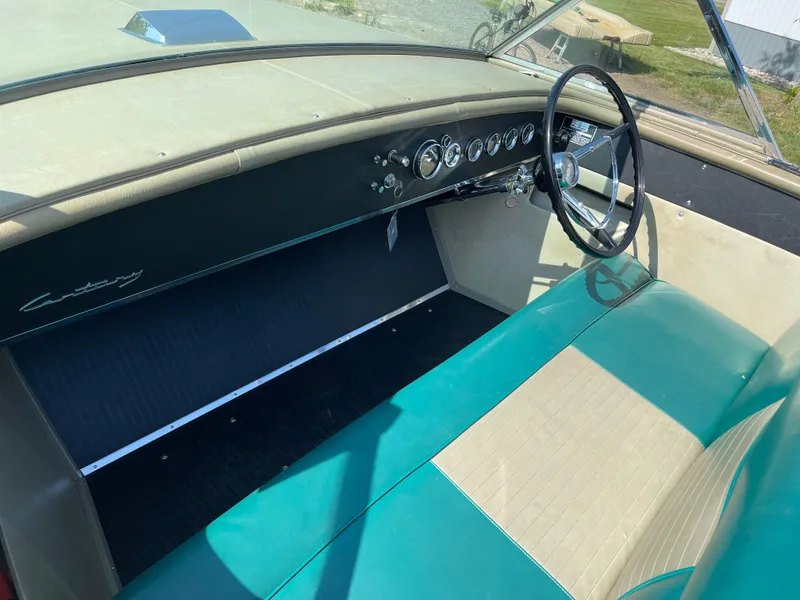 Slide: The Image of 1966 Century Resorter boat interior with teal and beige seating, classic dashboard, and steering wheel. - 16