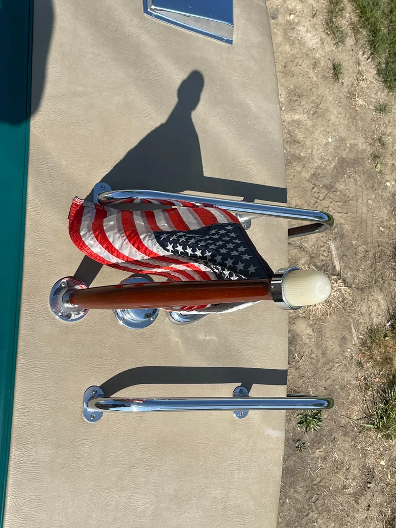 Slide: The Image of 1966 Century Resorter boat with American flag and chrome details on deck. - 22