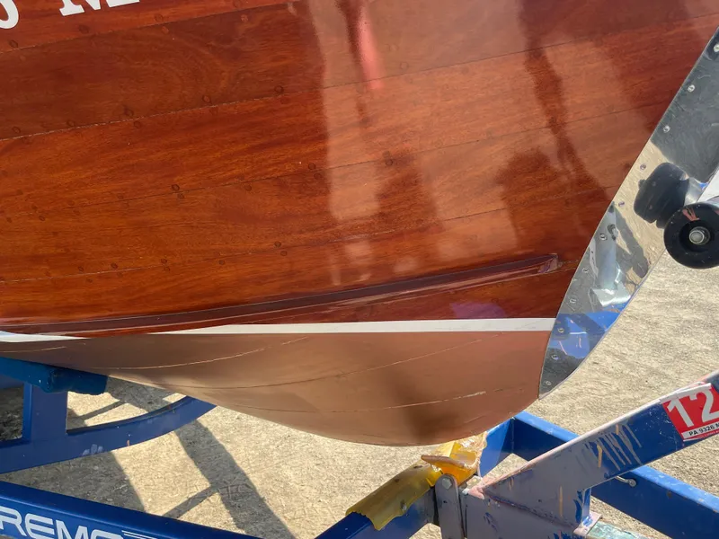 Slide: The Image of 1966 Century Resorter boat with polished wooden hull on a trailer. - 23