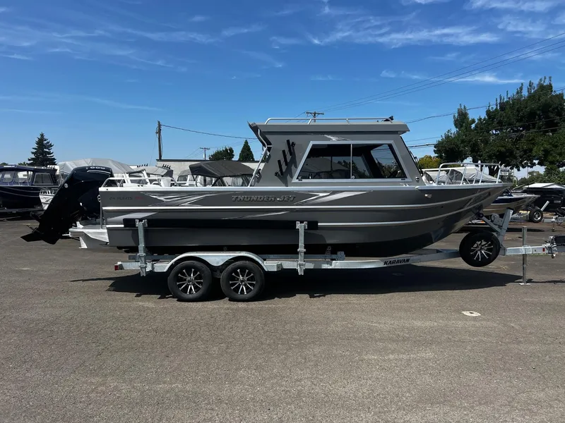 Slide: The Image of 2024 Thunder Jet 24 Alexis Pro boat on trailer under clear blue sky. - 1