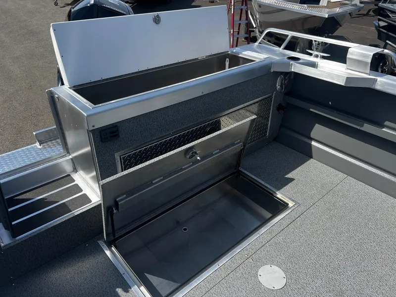 Slide: The Image of 2024 Thunder Jet 24 Alexis Pro boat interior with open storage compartments. - 10