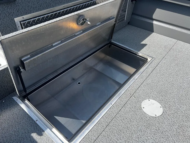 Slide: The Image of 2024 Thunder Jet 24 Alexis Pro boat storage compartment, open and empty. - 11