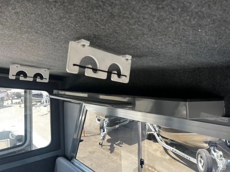 Slide: The Image of Interior of 2024 Thunder Jet 24 Alexis Pro boat with rod holders and window view. - 20